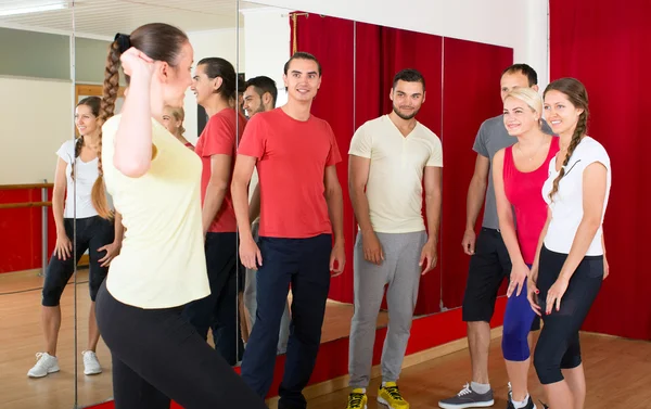 Trainer showing dancing moves to group