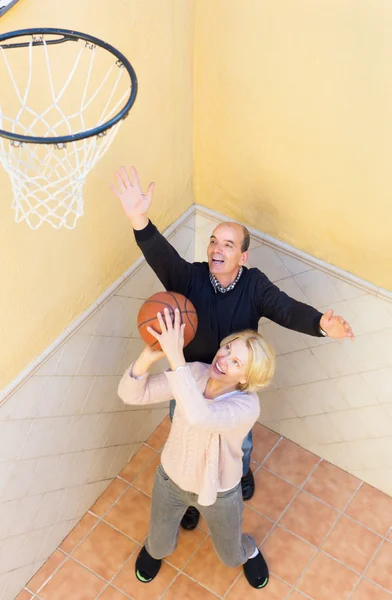 Senior spouses throwing the ball