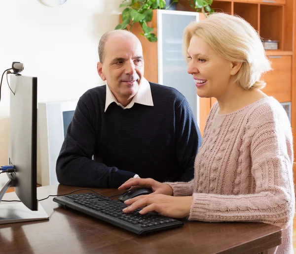 Senior couple talking with someone online