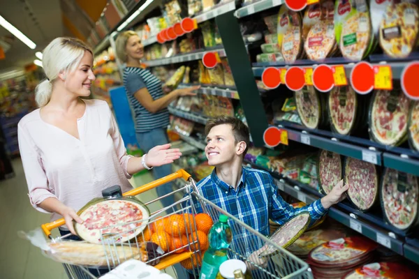 Spouses choosing pizza in store