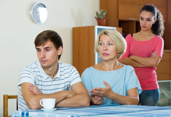 Man having argue with wife and mother-in-law