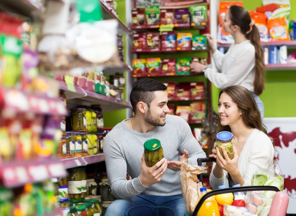 People purchasing food at supermarket