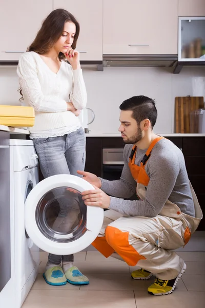 Housewife showing broken washing machine
