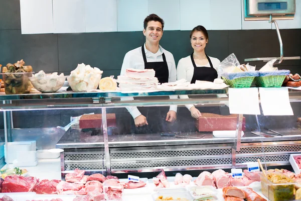 Store staff selling meat and salo