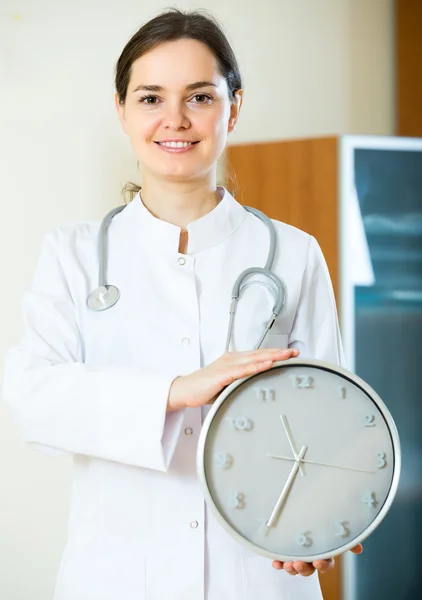 Family doctor with big clock