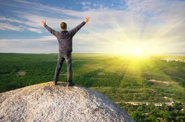 Man on top of mountain.