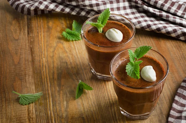 Homemade Chocolate Mousse in glasses on   a wooden table.