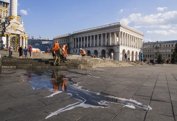 Workers hose down and clean Maidan