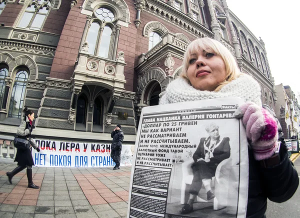 Woman holds newspaper at National Bank