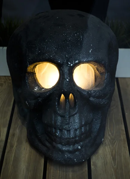 Skull with glowing eyes in a shop window.