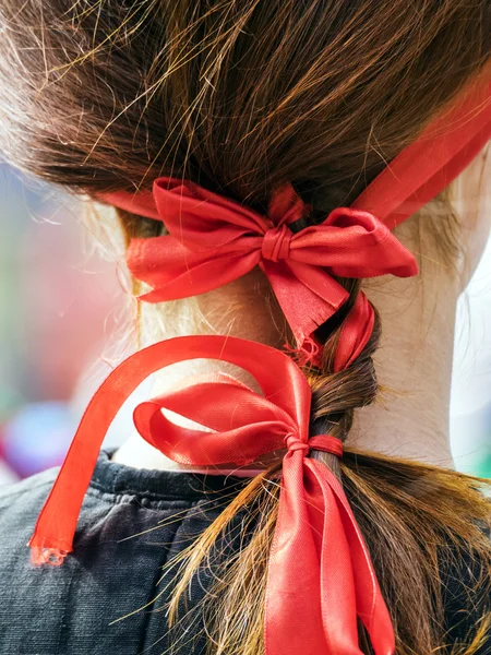Red bow in a woman hair