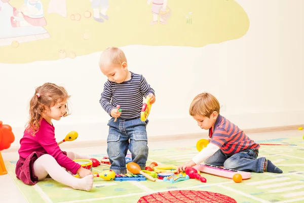 Three kids playing with toys