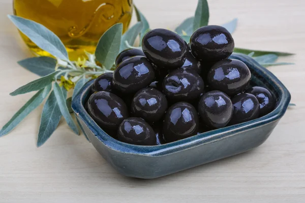 Black olives in bowl with oil