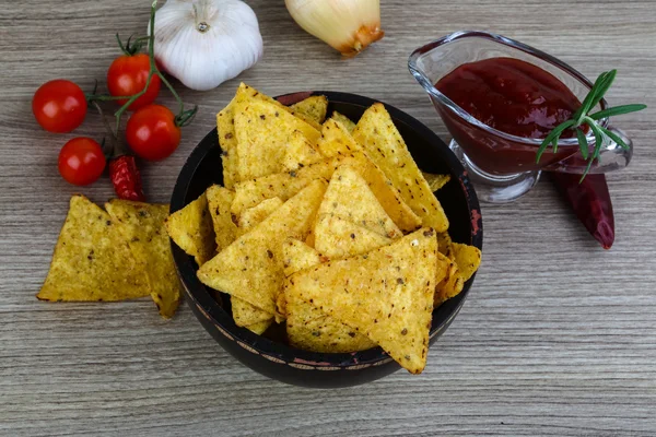 Nachos chips with tomato hot sauce