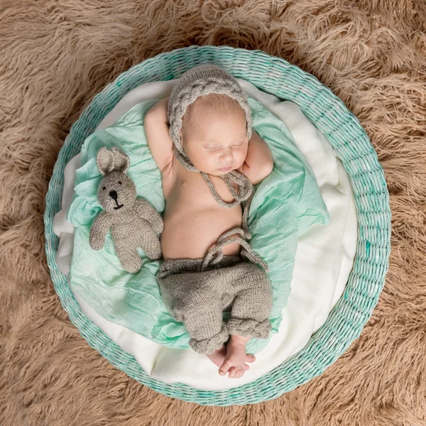 Newborn baby sleeping in round basket