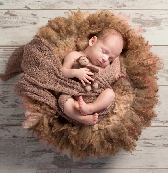 Beautiful baby sleeping sweet on fluffy round cot