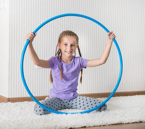 Girl  with hula hoop at home