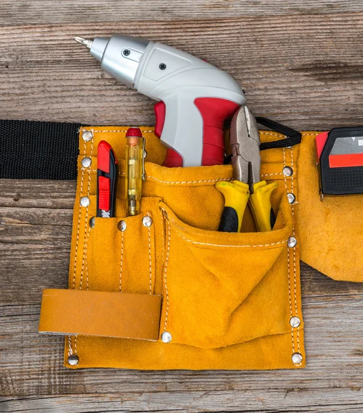 Tool belt with a screwdriver, pliers, screwdriver and knife