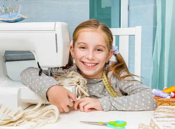 Little girl  with sewing machine