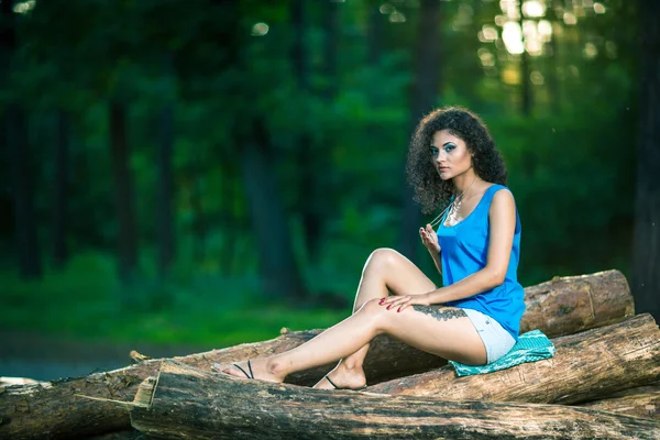 Woman sitting on log