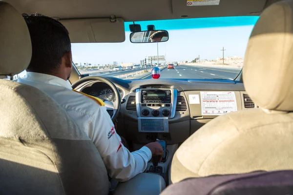 Taxi driver transporting passenger in Dubai