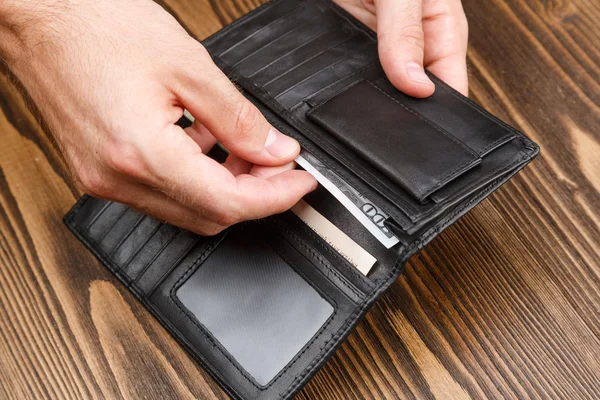 Black man's wallet in man hands
