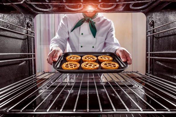 Chef cooking in the oven.