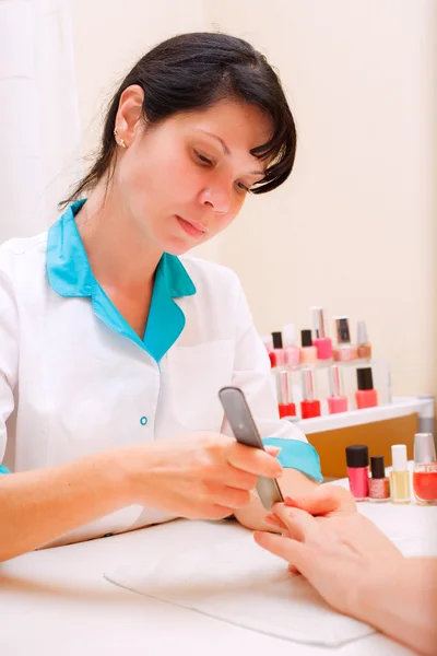 Manicure. Care of fingers of hands, cleaning, covering a varnish of nails.