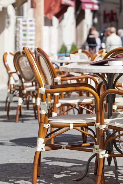 Tables and chairs in street cafe