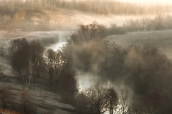 Surreal landscape with river mist