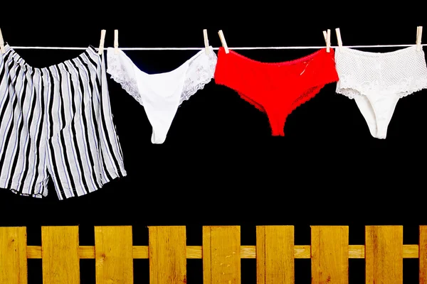 Woman panties and man underwear on clothesline