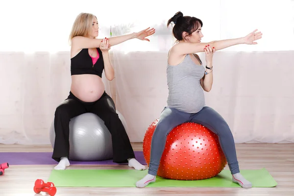 Pregnant women with large gymnastic balls