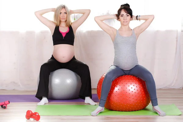 Pregnant women with large gymnastic balls