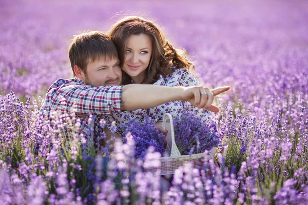 Happy young couple in a field of blooming lavender