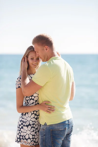 Young loving couple on the beach near the sea