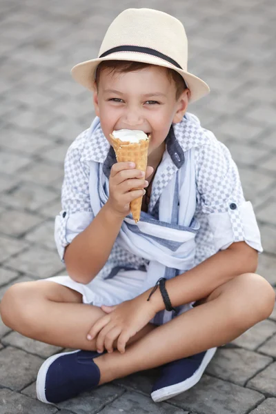 Happy baby boy eating ice cream