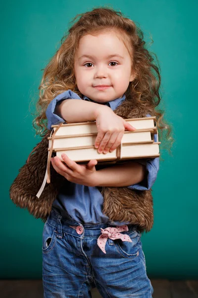 Ortrait of a little girl with books in their hands.