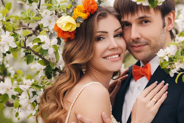 The bride and groom - photo in a flowery Park in the spring.