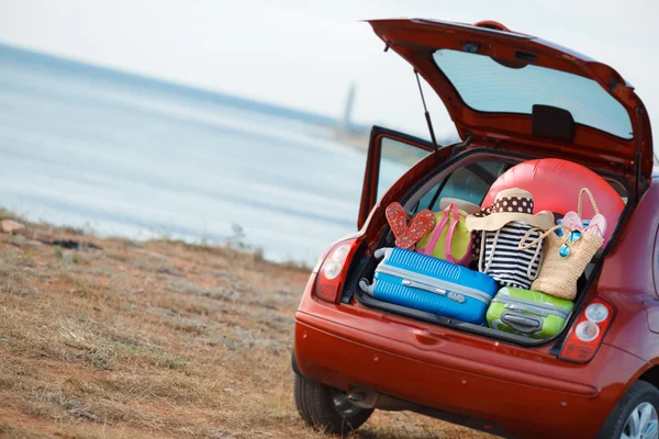 Suitcases and bags in trunk of car ready to depart for holidays