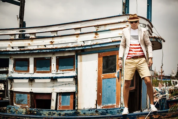 Sexy  man on old boat, fashion lifestyle concept
