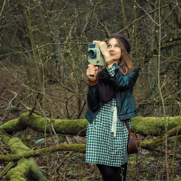 Hipster girl with vintage movie camera