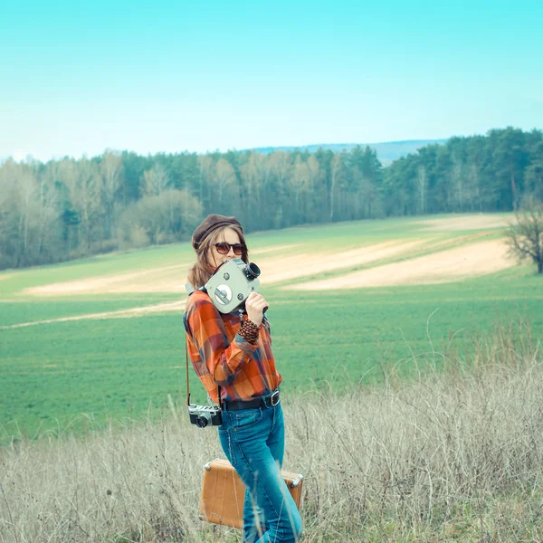 Hipster girl with vintage camera outdoors