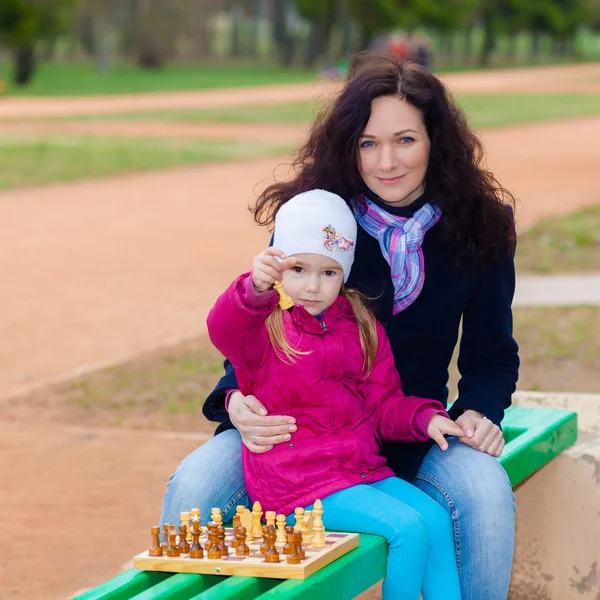 Mother and daughter playing chess