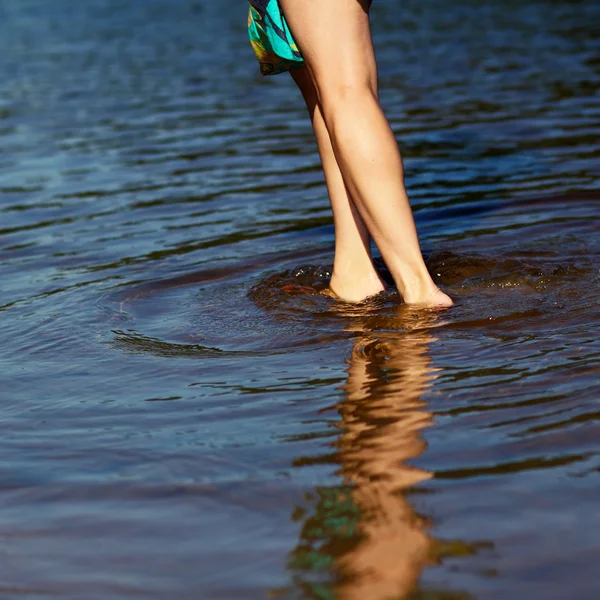 Girl walks through the shallow water