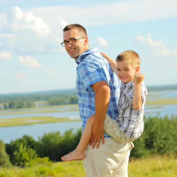 Father giving his son piggyback ride