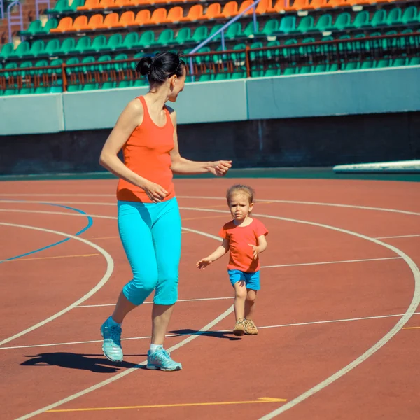 Mother and daughter sport training in stadium