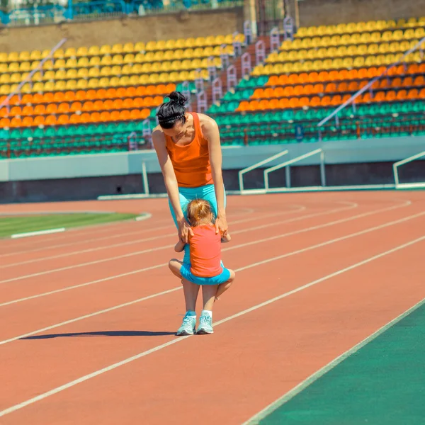 Mother and daughter sport training in stadium