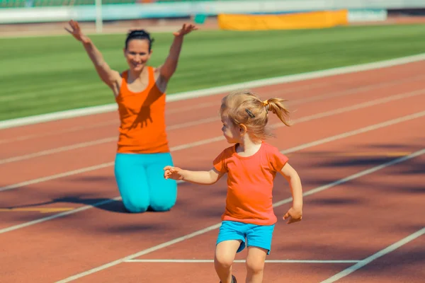 Mother and daughter sport training in stadium