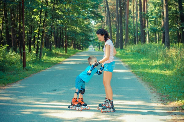 Mother and son learn to roller skate