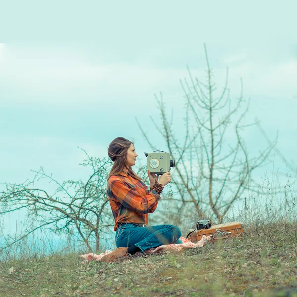 Girl in a plaid shirt  with vintage camera